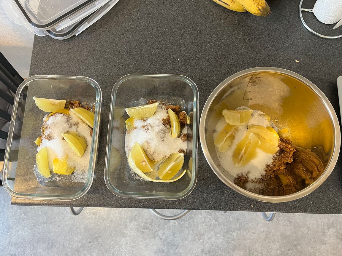 Lemon peels and slices mixed with sugar in a bowl