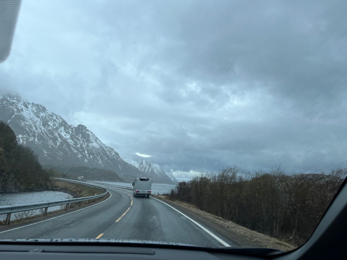 Lofoten mountains with an RV driving on the foreground