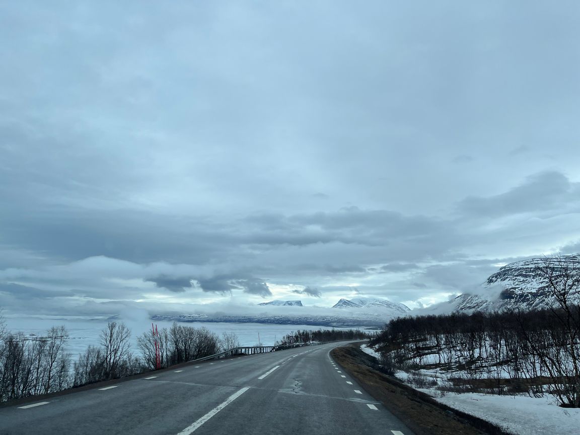 Lapporten surrounded by clouds, with the road on the foreground